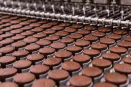 Chocolate cupcakes coming down food production line at Tastykake facility in Philadelphia, Pennsylvania.